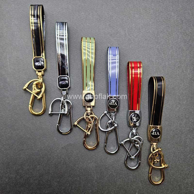 آویز-براق-تی-پی-یو-01 آویز کلید پلاستیکی با نوار طلایی - Image 1