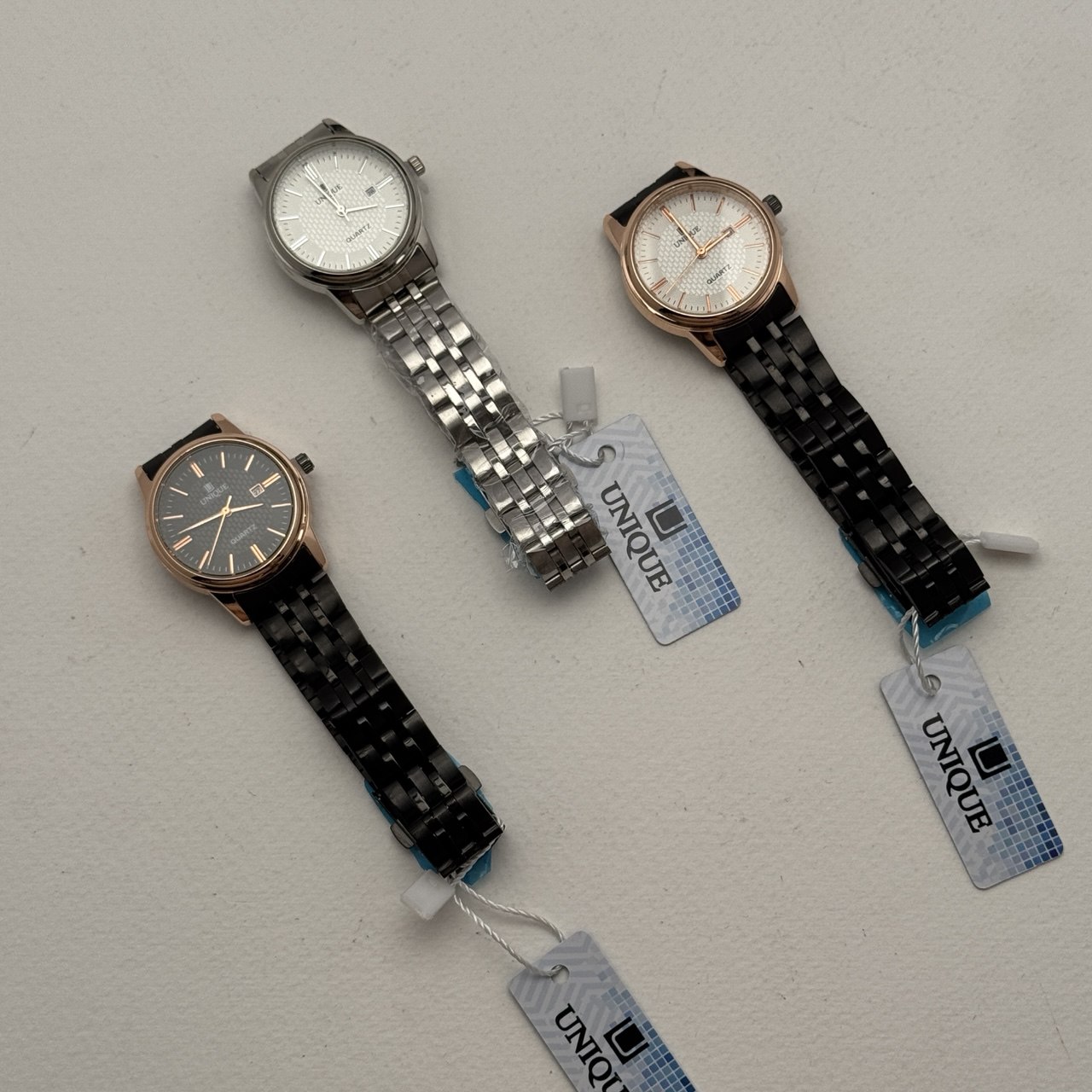 photo_3_2025-04-10_13-25-55 ساعت مچی طرح UNIQE با بند استیل - Image 1